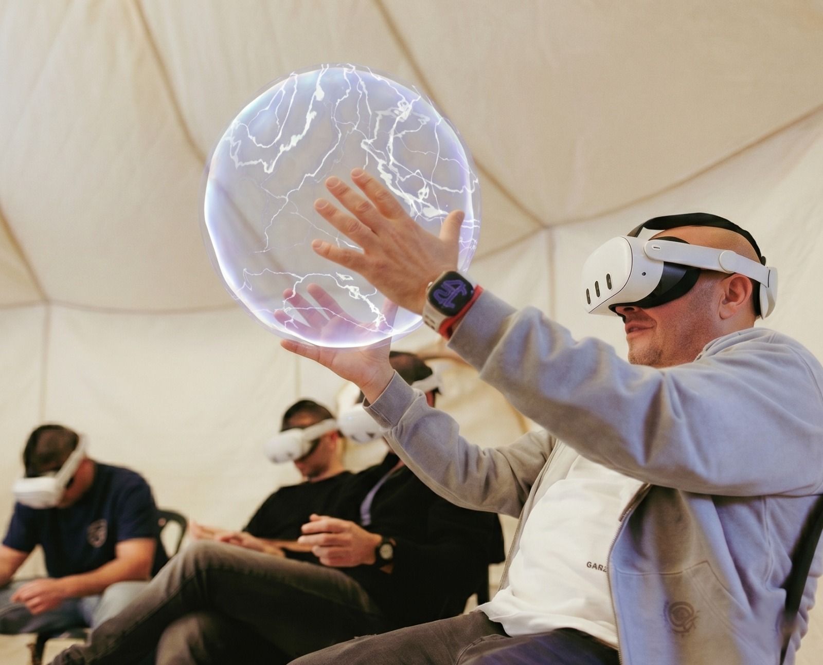 Person wearing Meta Quest headset interacting with a virtual sphere in mixed reality